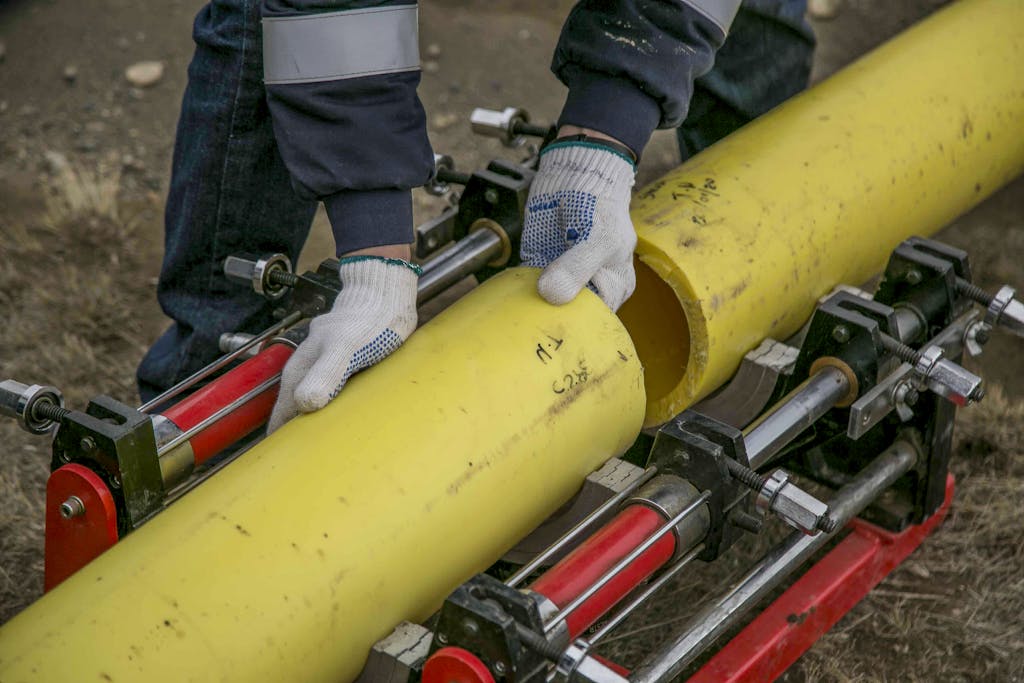 A Person Holding Yellow Pipes